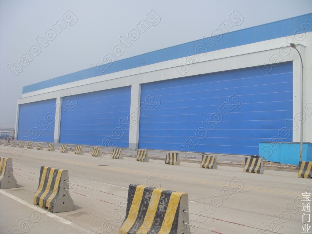门业图片-出海口大门供应出海口大门 沈阳宝通门业024-23786011/侧转门/民用车库门/机库门/柔性升降大门非标图片